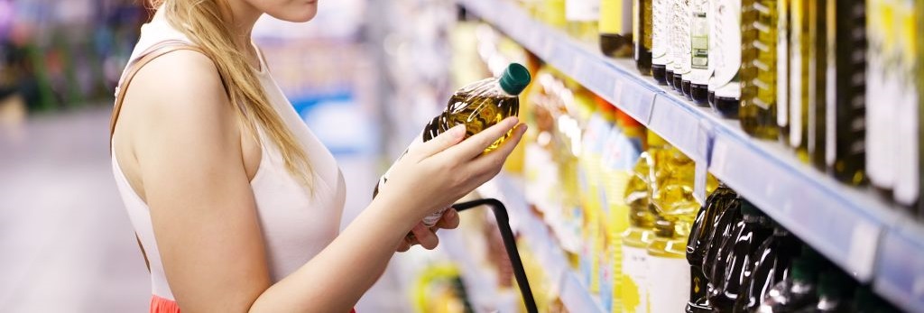 Young woman buying olive oil