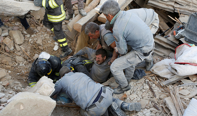 A man is rescued alive from the ruins following an earthquake in Amatrice